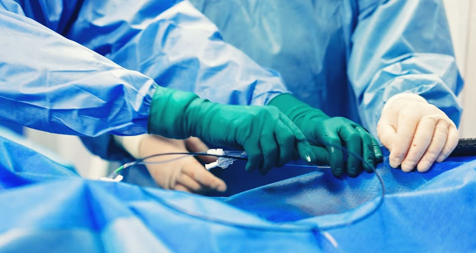 Doctors performing transcatheter aortic valve replacement (TAVR) on a patient