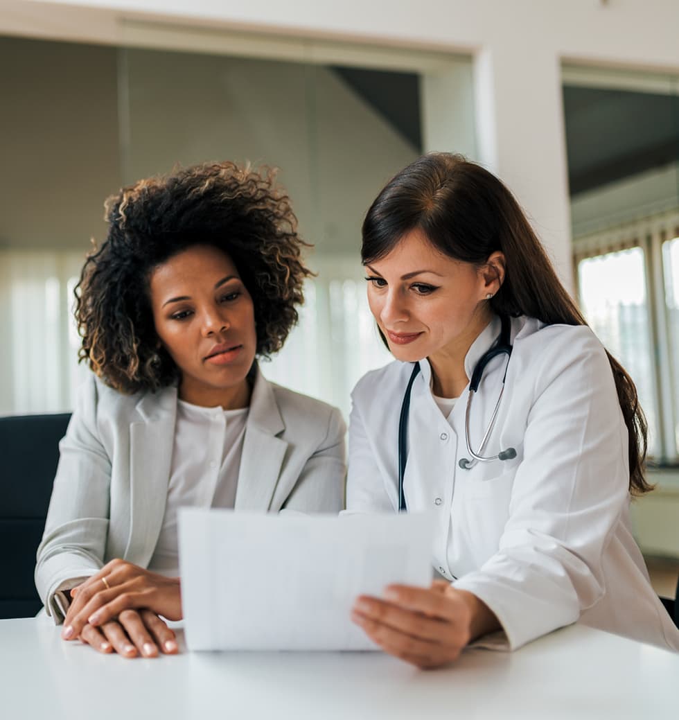 Doctor reviewing paperwork with patient